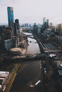 High angle view of river amidst buildings against sky