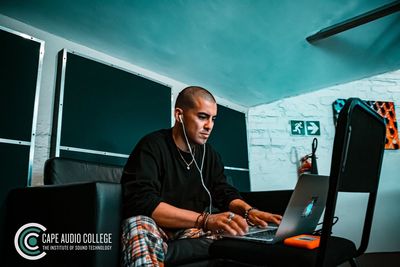 Young man using mobile phone in office