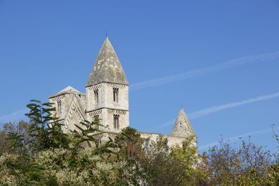 Low angle view of building against clear blue sky