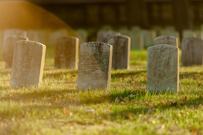 Cross on field at cemetery