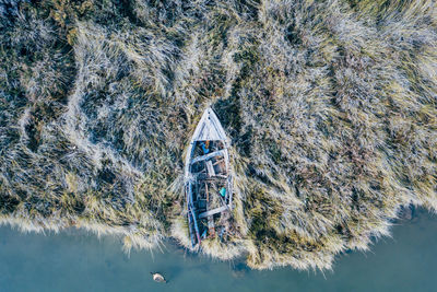 Directly above shot of abandoned boat on bush in sea