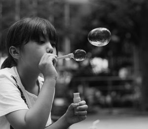 Young woman blowing bubbles