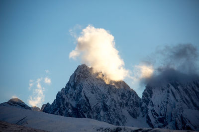 Scenic view of snowcapped mountains against clear sky