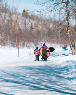 People riding motorcycle on snow covered field