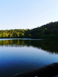 Scenic view of lake against clear blue sky