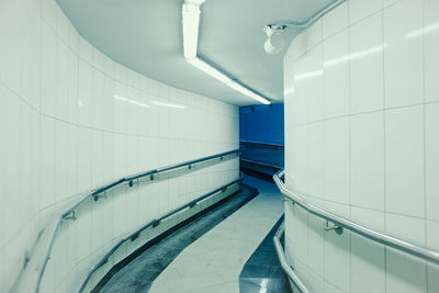 Low angle view of people walking on escalator