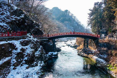 Arch bridge over river during winter