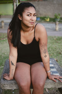 Portrait of young woman sitting outdoors