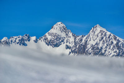 Scenic view of snowcapped mountains against sky