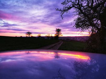 Scenic view of lake against sky at sunset