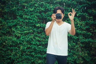 Full length of a man holding camera