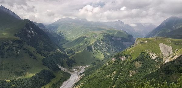 Aerial view of valley and mountains against sky