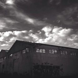 Low angle view of building against cloudy sky