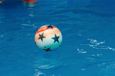 High angle view of ball floating in swimming pool