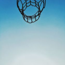 Low angle view of basketball hoop against blue sky