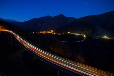 High angle view of light trails on road against sky at night