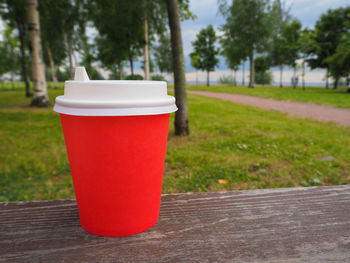 Close-up of drink on table by footpath