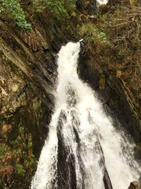 View of water flowing through rocks