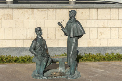 Statue against wall in city