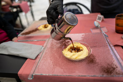 Close-up of person preparing food on table