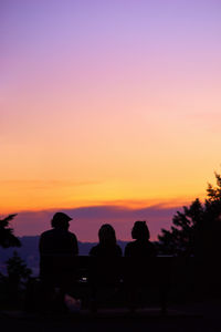 Silhouette of sun in front of dramatic sky during sunset