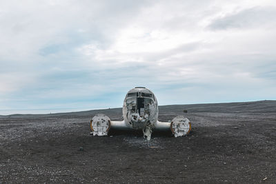 Abandoned machinery on land against sky