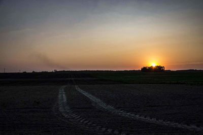 Scenic view of field against sky during sunset