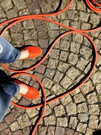 Low section of woman standing on tiled floor