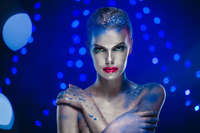 Portrait of woman with illuminated lighting equipment