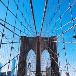 Low angle view of bridge against blue sky