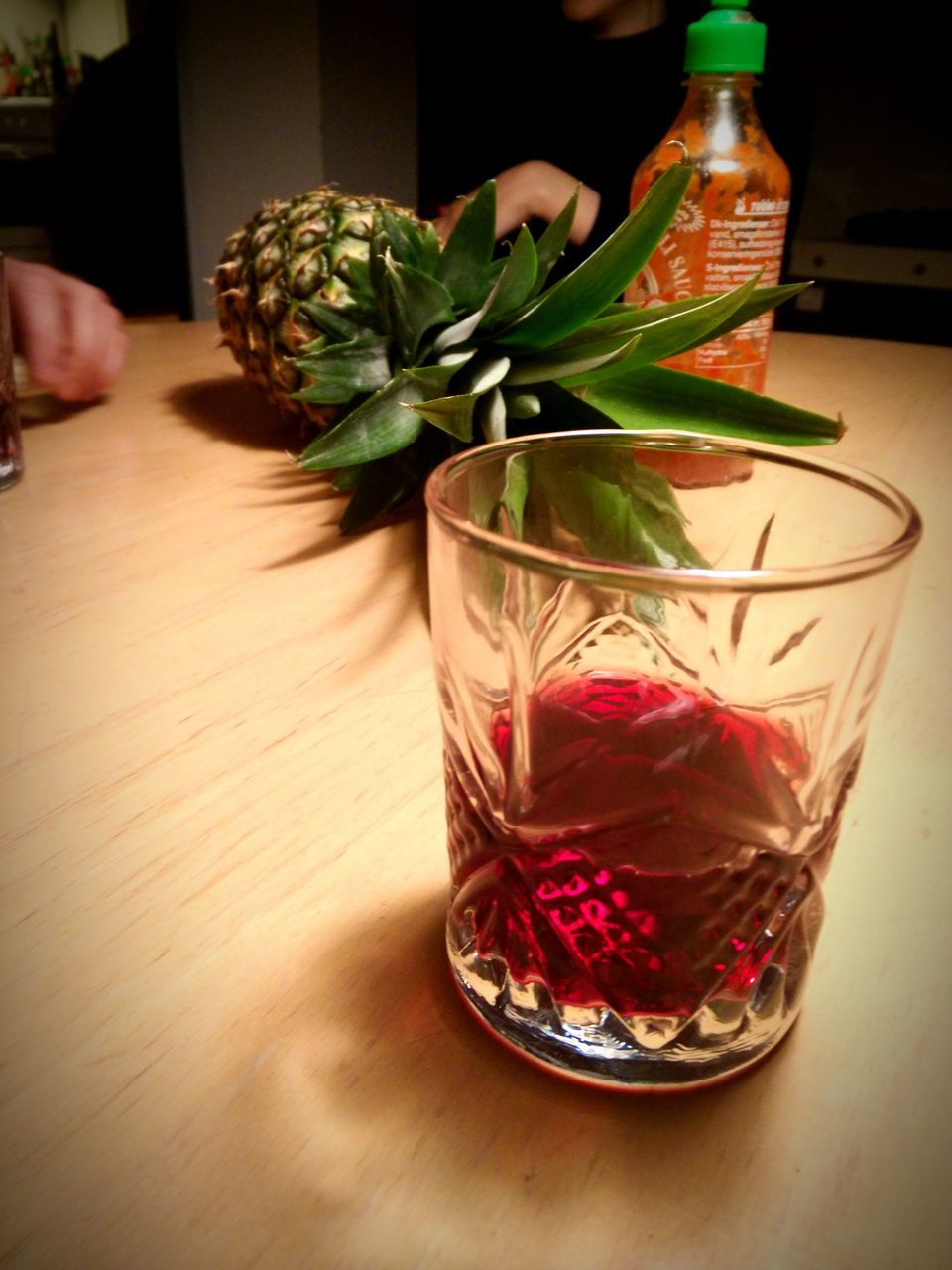 indoors, table, freshness, vase, still life, food and drink, drinking glass, potted plant, glass - material, drink, home interior, close-up, wood - material, flower, leaf, decoration, high angle view, refreshment, green color, plant