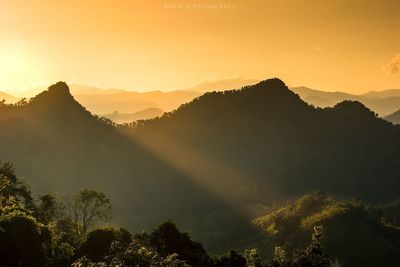 Scenic view of silhouette mountains against sky during sunset