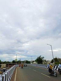 Vehicles on road against sky