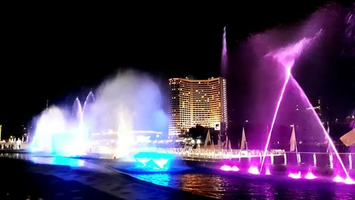 Illuminated buildings in city at night