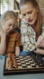 Mother and daughter playing chess