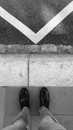 Low section of man standing on footpath