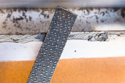 High angle view of rusty metal chain against wall