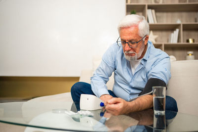Young man using mobile phone at home