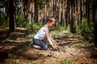 Side view of boy in forest