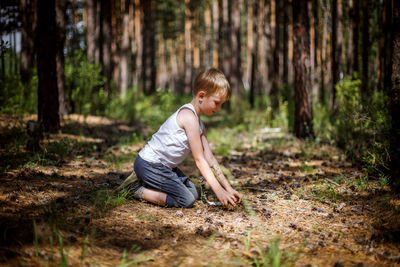 Side view of a boy in forest