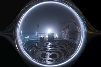 Digital composite image of illuminated city against sky at night