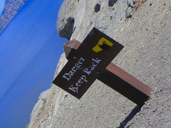 Information sign against blue sky