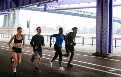 People running on road in city