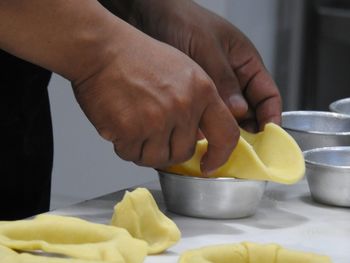 Close-up of man holding food on table