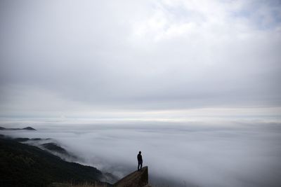 Scenic view of mountains against cloudy sky