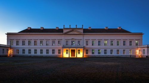 Building against clear blue sky at night