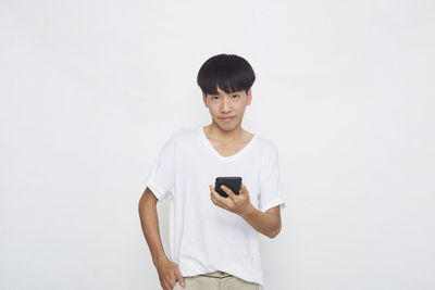 Man using smart phone against white background