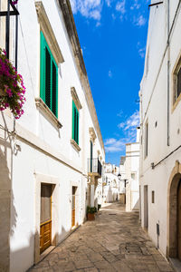 Street amidst buildings in town against sky