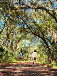Rear view of people walking in park