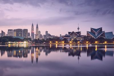 Reflection of illuminated buildings in lake at night